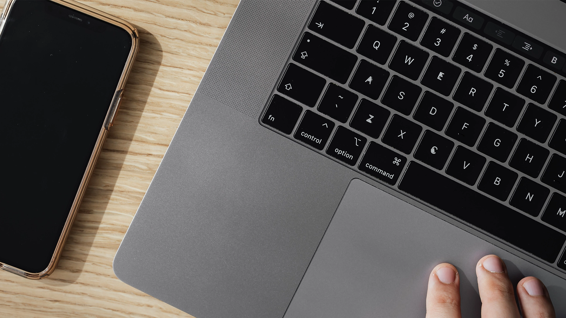 celular e laptop em cima de uma mesa de madeira